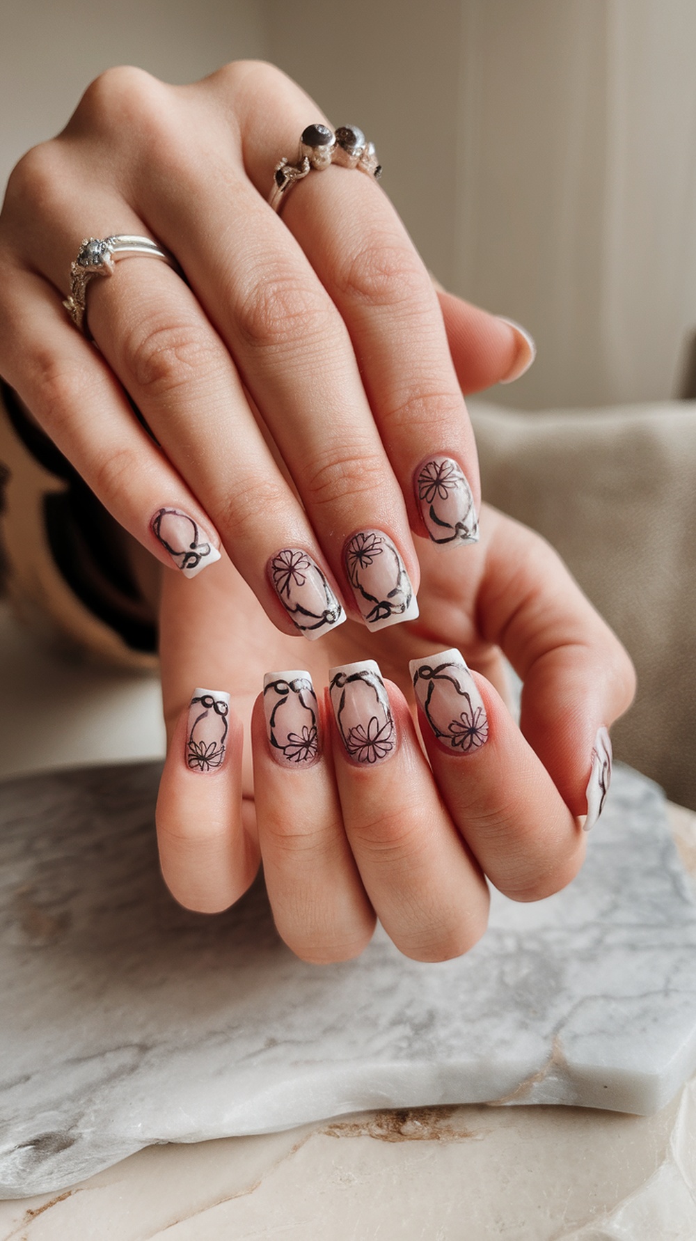 Negative space sunflower nail design with clear sections and floral outlines