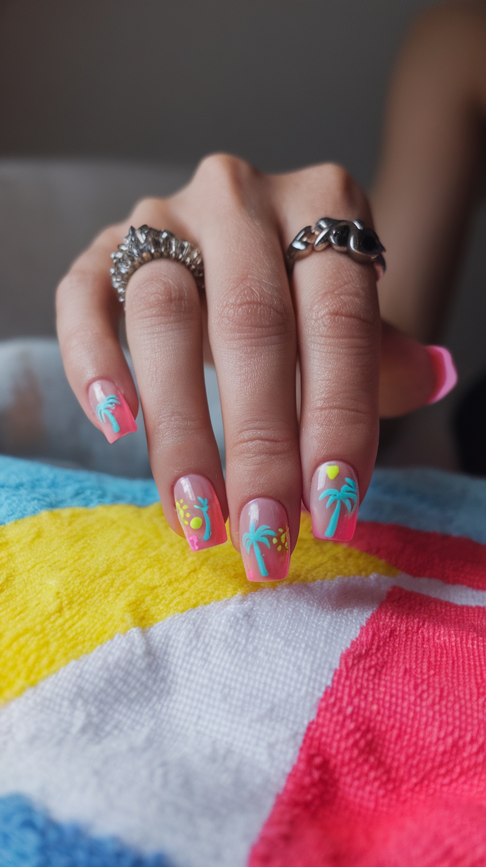 Colorful beach-themed nails with palm trees and bright colors
