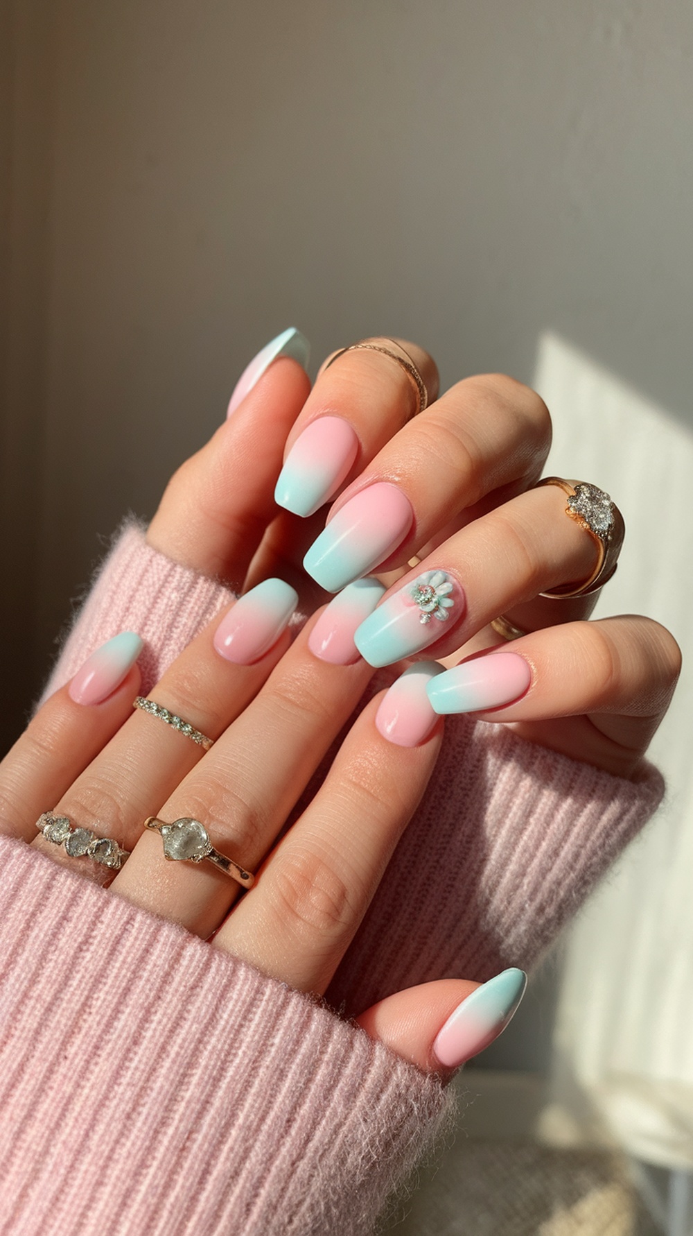 Pastel ombre nails featuring pink and blue colors with a floral design