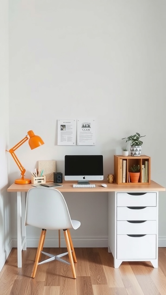 A small, stylish desk setup featuring a light wood top, white drawers, an orange lamp, and a computer, perfect for small spaces.