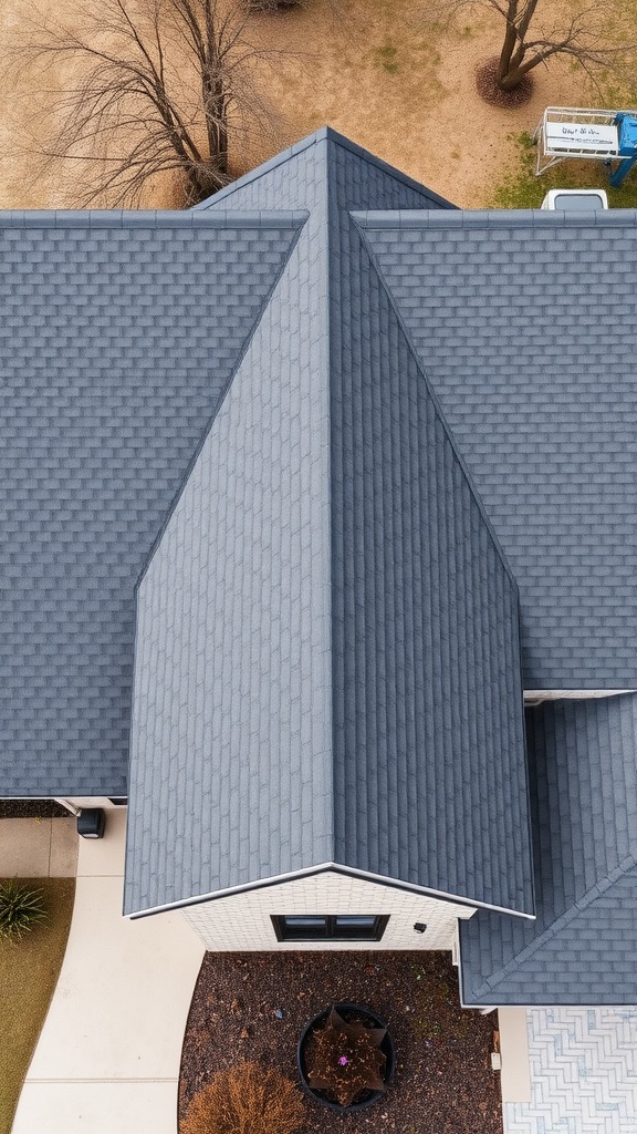 Aerial view of a roof with dark shingles on a gray brick house.