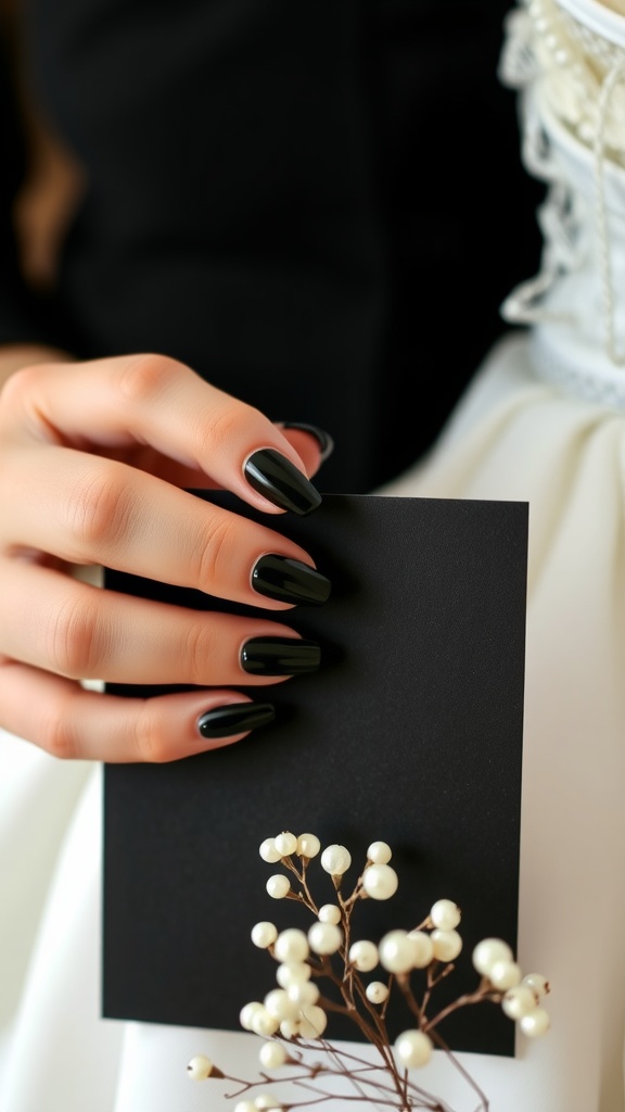 A hand with long black nails holding a black card, with a white wedding dress and pearl accents in the background.