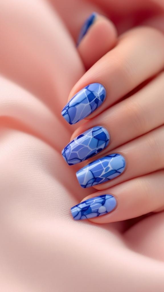 Nails featuring a blue marble effect design with intricate patterns.