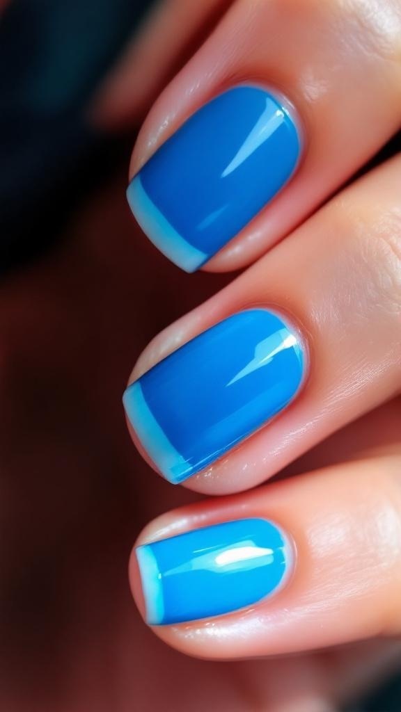 Electric blue French tip nails with a vibrant blue base and lighter blue tips.
