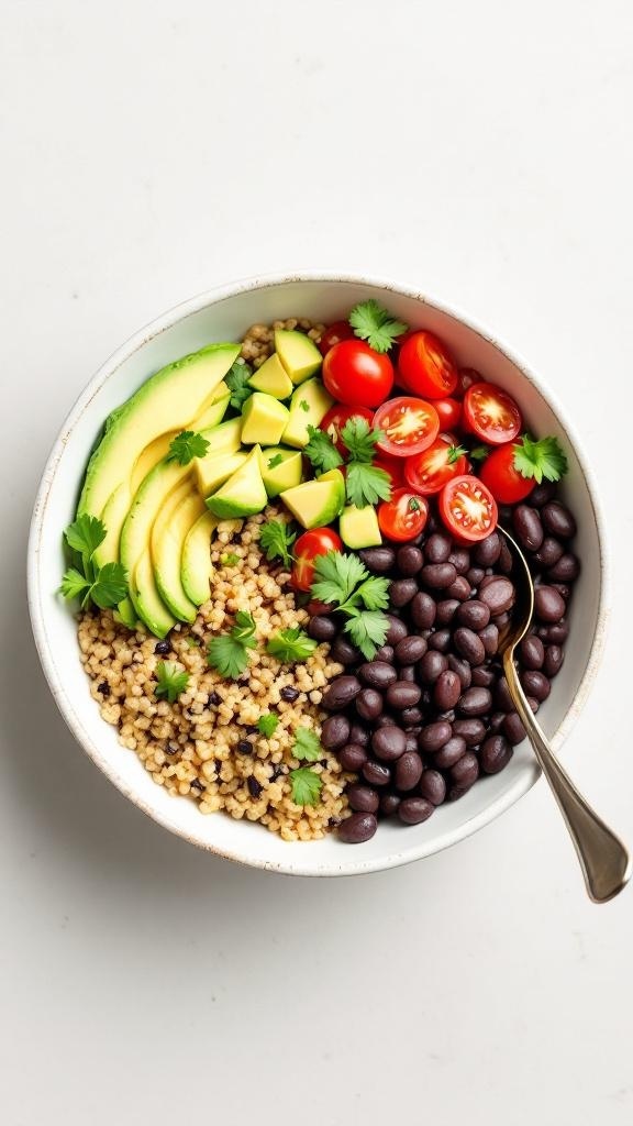 A colorful quinoa and black bean bowl with avocado, cherry tomatoes, and cilantro.