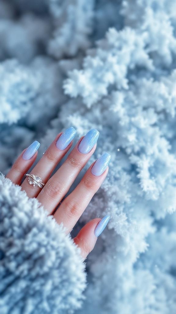 A hand with icy blue gradient nails against a fluffy background.