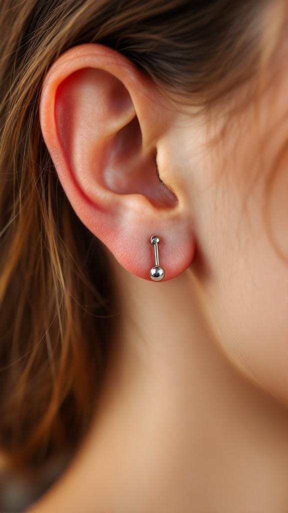 Close-up of an industrial piercing with a barbell in a person's ear.