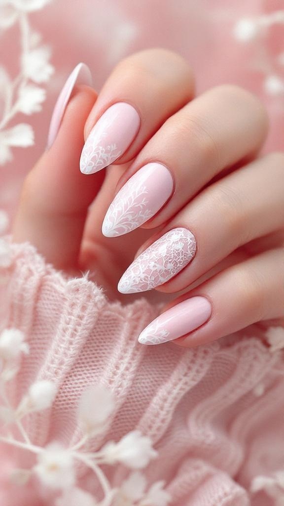 Nails painted in soft pink with intricate white lace designs on some nails, showcasing a feminine and elegant style.