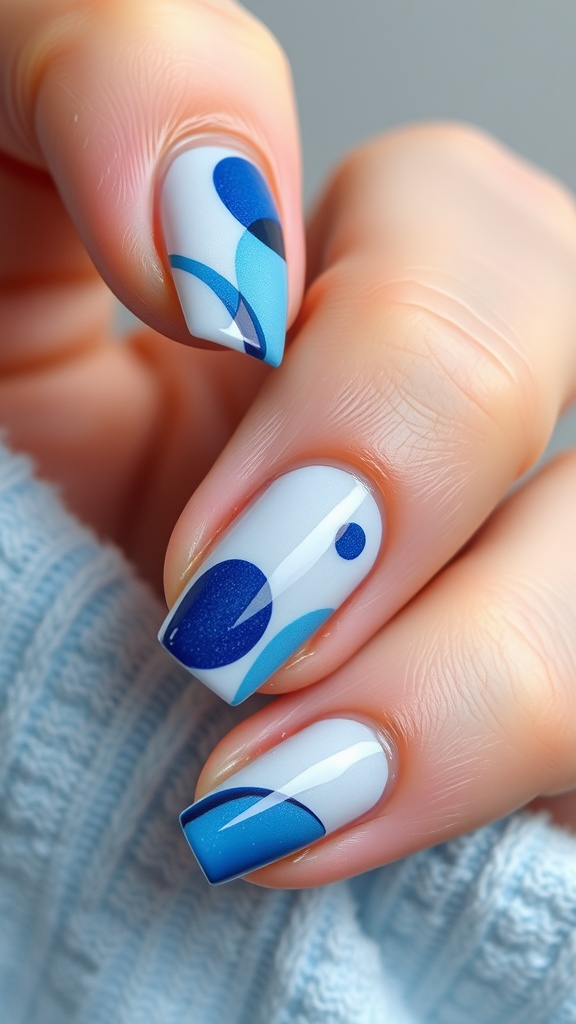 Light and dark blue abstract nail design with unique shapes.