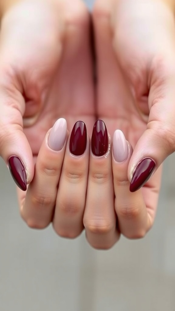 A close-up of hands showing almond-shaped nails with a burgundy and beige ombre effect.