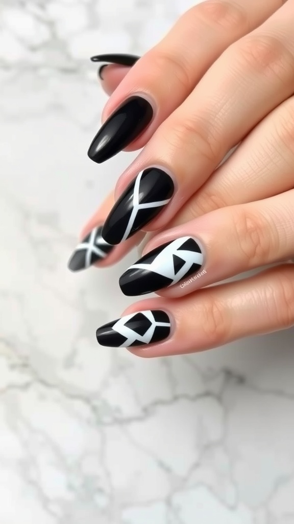 Black acrylic nails with white geometric patterns.