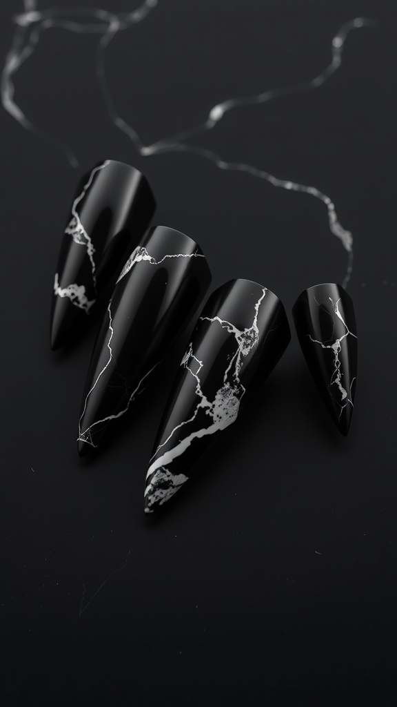 Image of black coffin-shaped nails with a marble effect pattern in white.