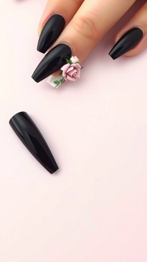 Close-up of coffin-shaped black nails with a floral accent