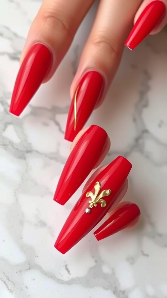 Bold cherry red acrylic nails with gold accents.