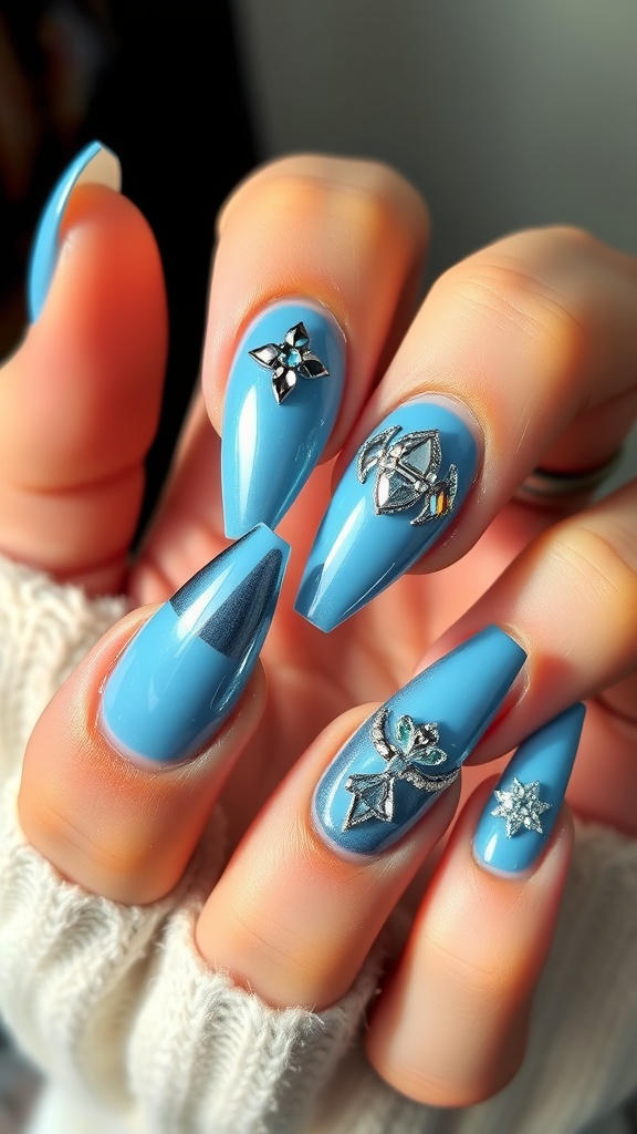Nails painted in light blue chrome with various bold shapes and designs.