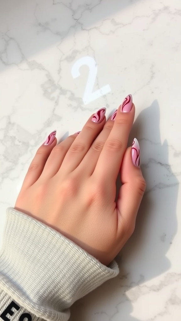 Hand with cherry marble nail design on a marble surface
