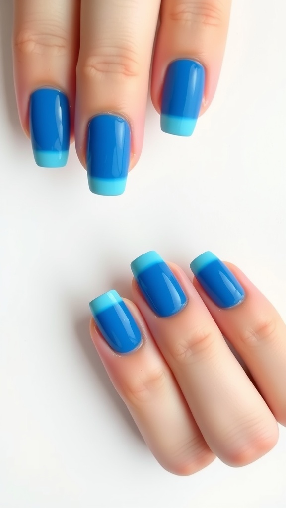 Image of blue French tip nails with a vibrant blue base and soft aqua tips.