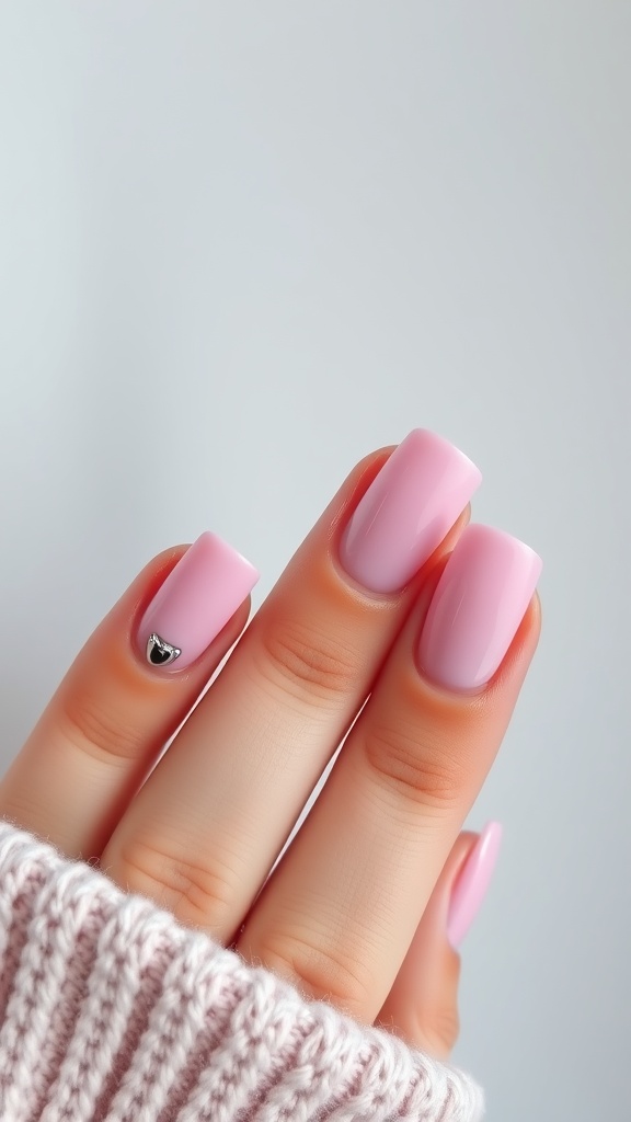 Pink French tip nails with a chrome accent, showcasing a modern and elegant design.