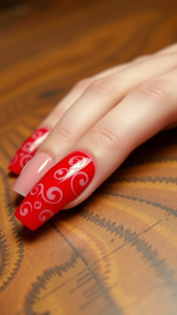 Close-up view of classic red coffin nails with white swirl designs on a wooden surface