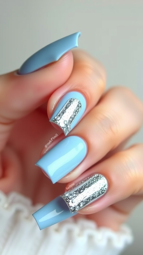 Light blue chrome nails with silver foil accents