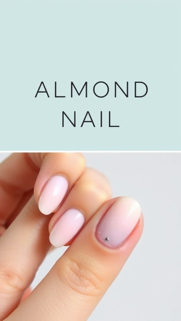 A close-up view of almond-shaped nails with a gradient effect and a small gem.