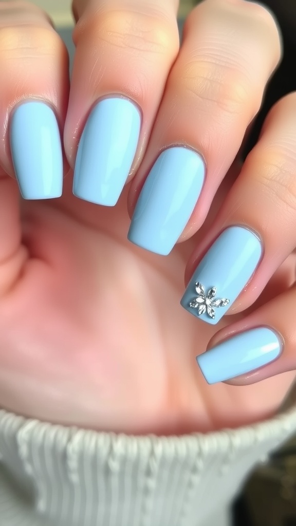 Light blue nails with rhinestone accent on one finger