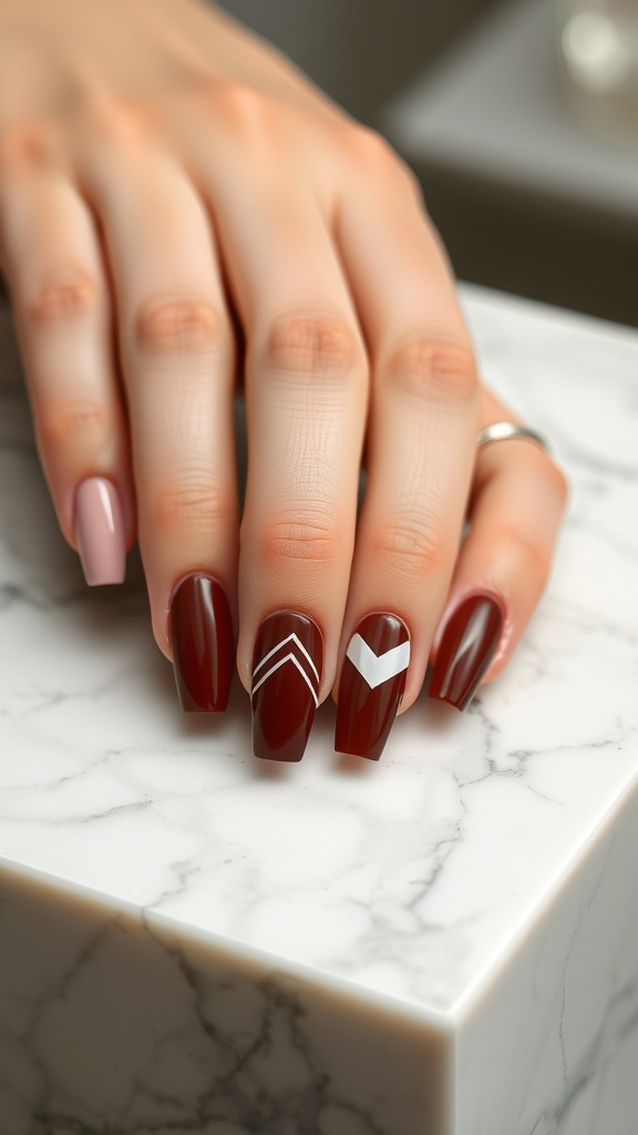 A hand with deep chestnut nails featuring minimalist art, displayed on a marble surface.