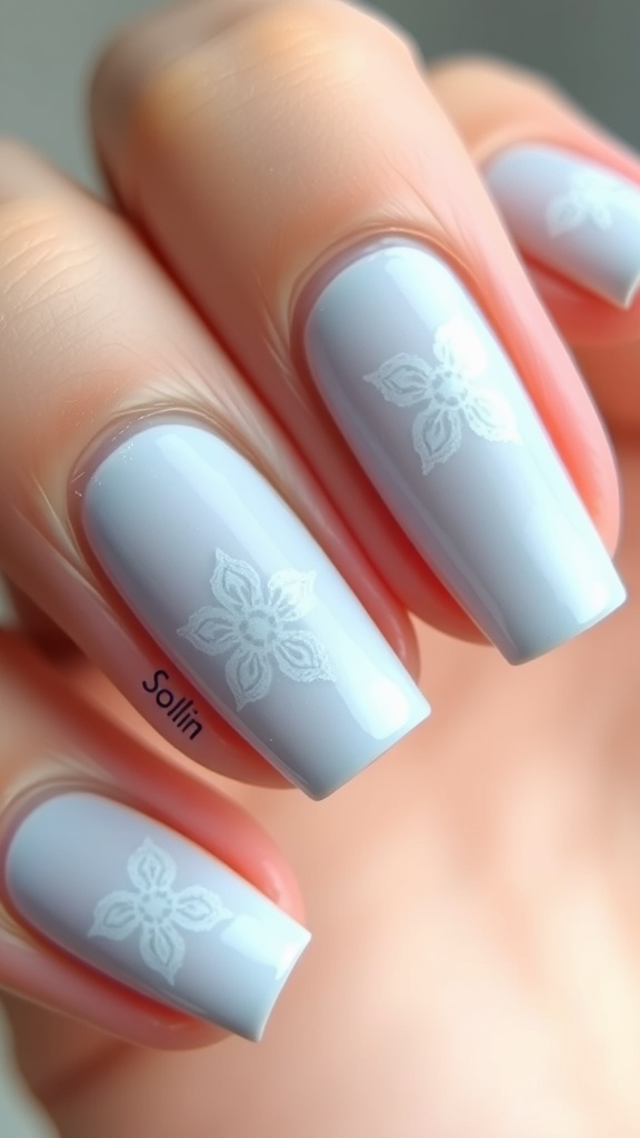 Light blue nails with white flower patterns
