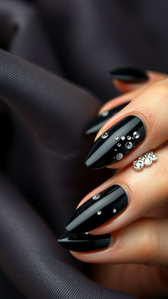 Elegant black almond nails with rhinestones on a dark background