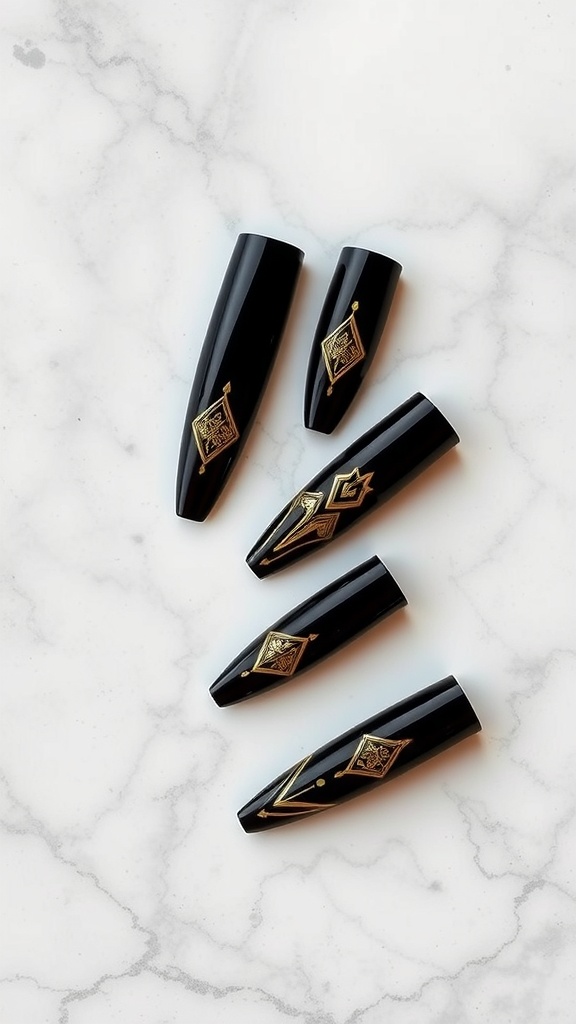 Elegant black coffin nails with gold designs on a marble surface.