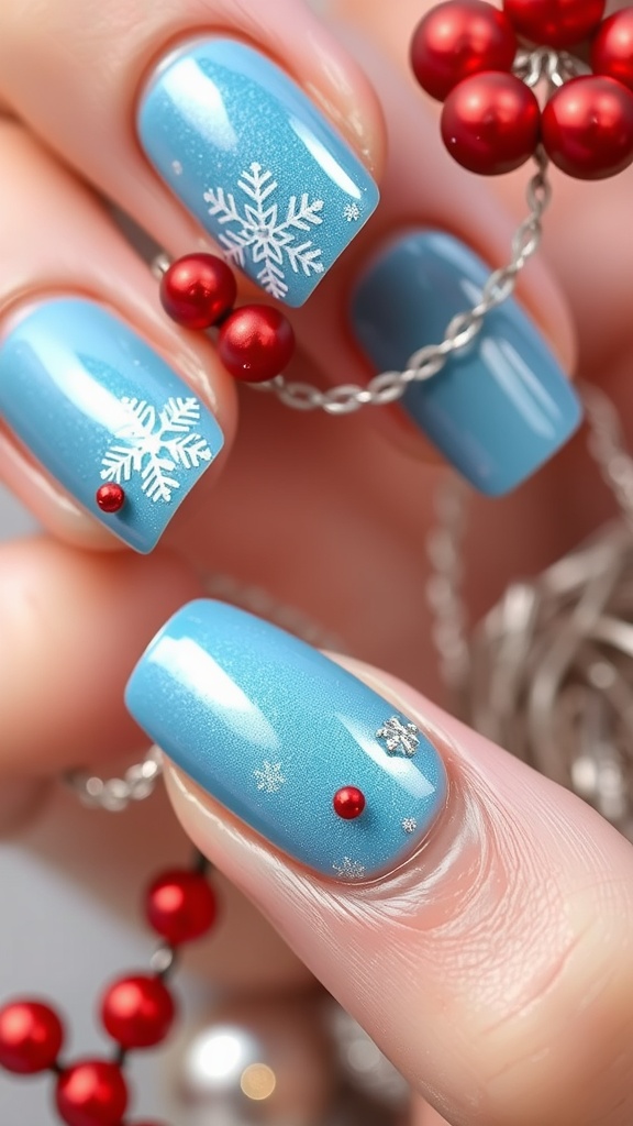 Close-up of festive light blue chrome nails with snowflake designs and red beads
