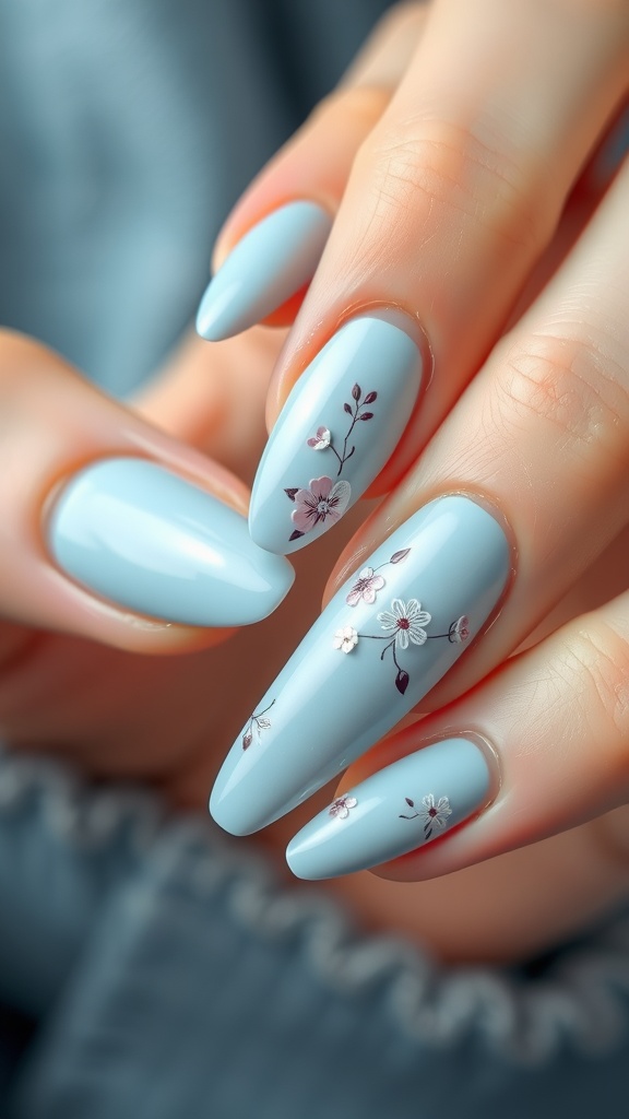 Close-up of light blue nails with floral accents.