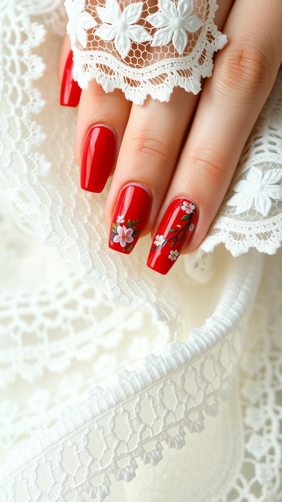 Close-up of red nails with floral designs, placed on a lace fabric