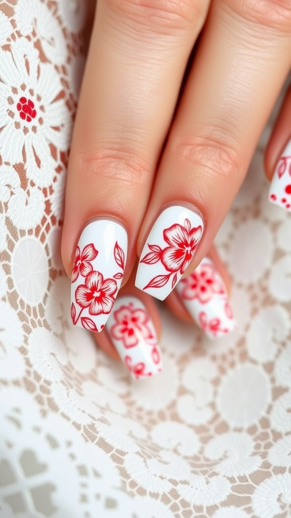 Close-up of floral red nail art on a white background with intricate designs