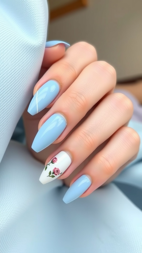 Nails painted light blue with a floral design featuring pink roses on one nail.
