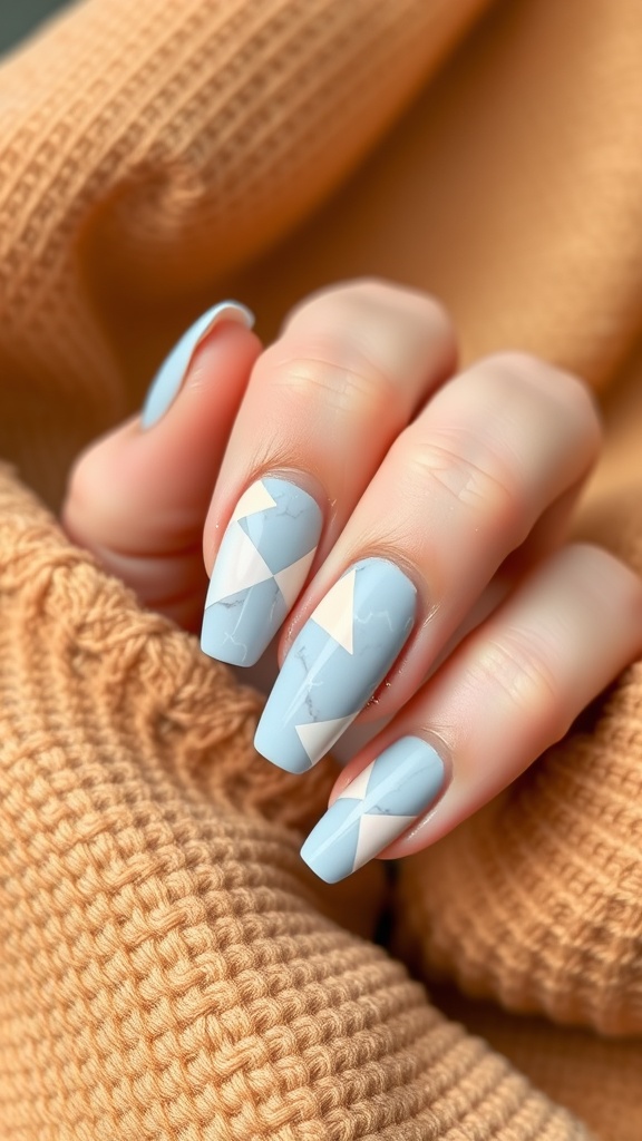 Close-up of light blue marble nails with geometric patterns