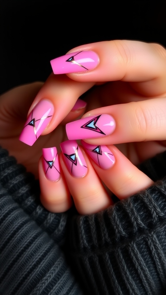 Pink chrome nails with geometric patterns featuring black triangles