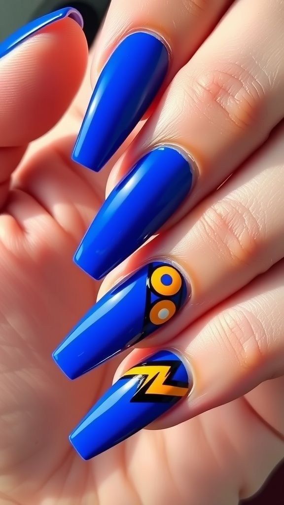 Close-up of royal blue acrylic nails with geometric patterns in orange and black.