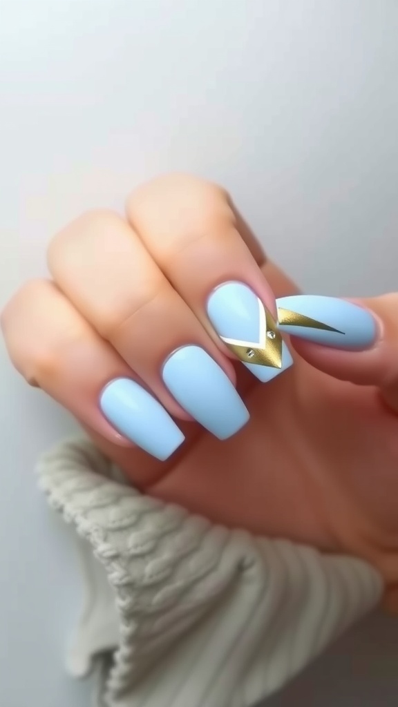 Light blue acrylic nails with geometric patterns and gold accents.