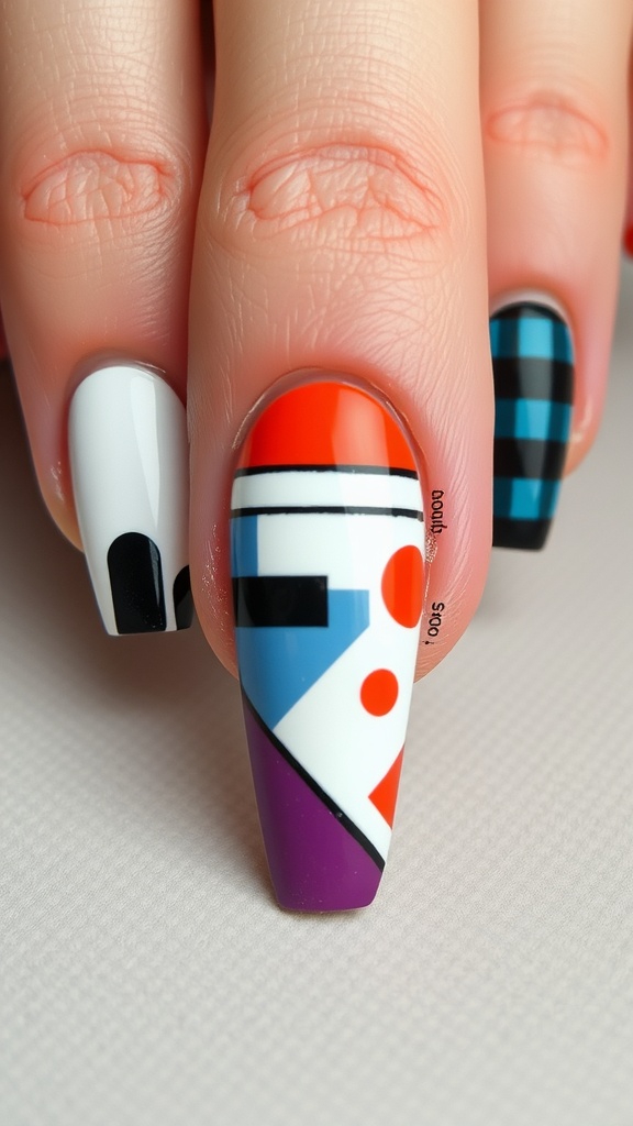 Close-up of medium coffin nails featuring geometric shapes in bold colors.