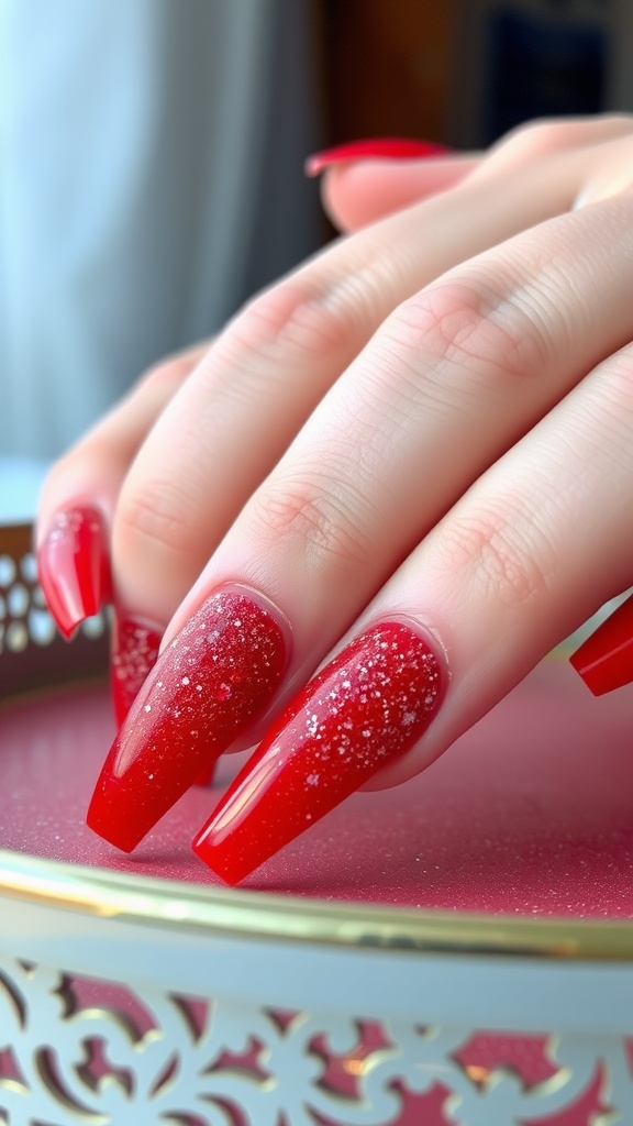 Close-up of hands with long red ombre glitter acrylic nails