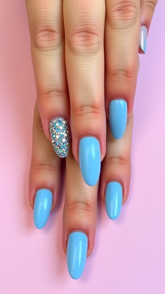 Close-up of hands with baby blue acrylic nails featuring a glittery accent nail.