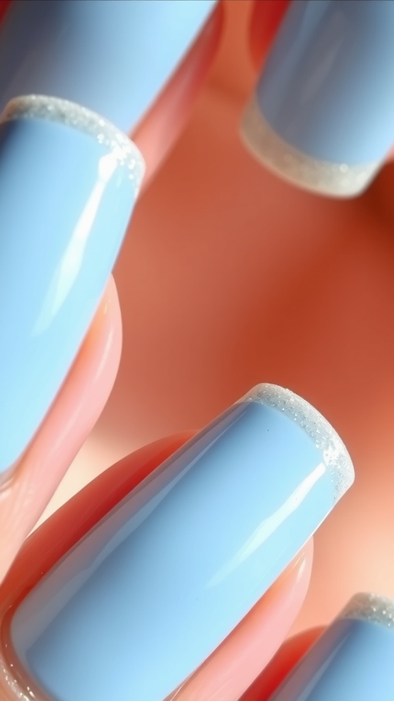 Nails with light blue polish and glittery tips