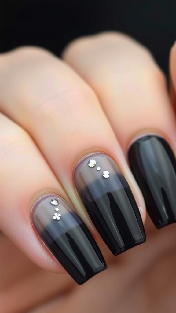 Glossy black ombre acrylic nails with rhinestone accents