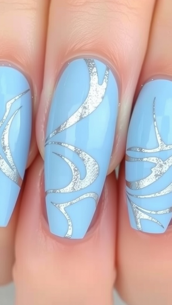 Close-up of light blue acrylic nails featuring a silver marble effect design.