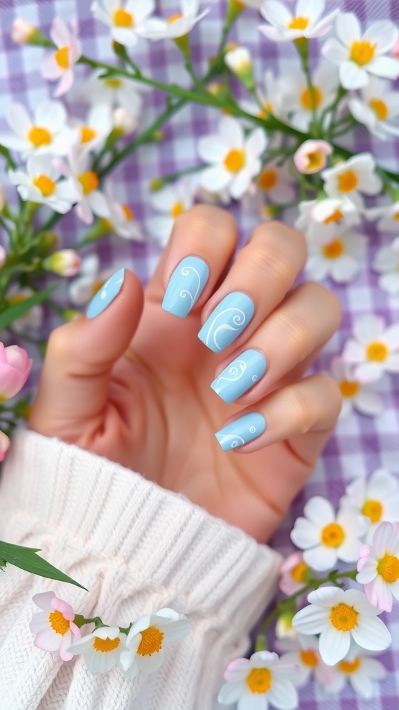 Light blue nails with white swirls held against a floral background
