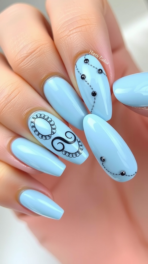 Light blue nails with black accents and intricate designs