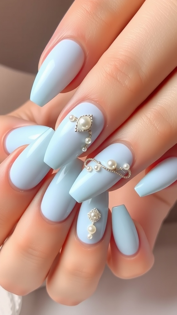 Light blue acrylic nails with pearl accents, showcasing a glossy finish and intricate nail art design.