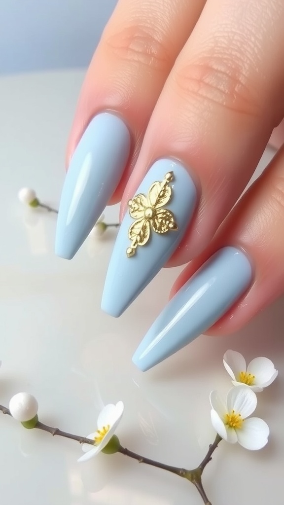 Light blue nails with metallic gold butterfly accent