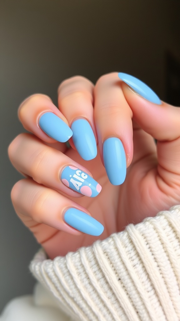 Light blue nails with negative space design featuring dots and letters.